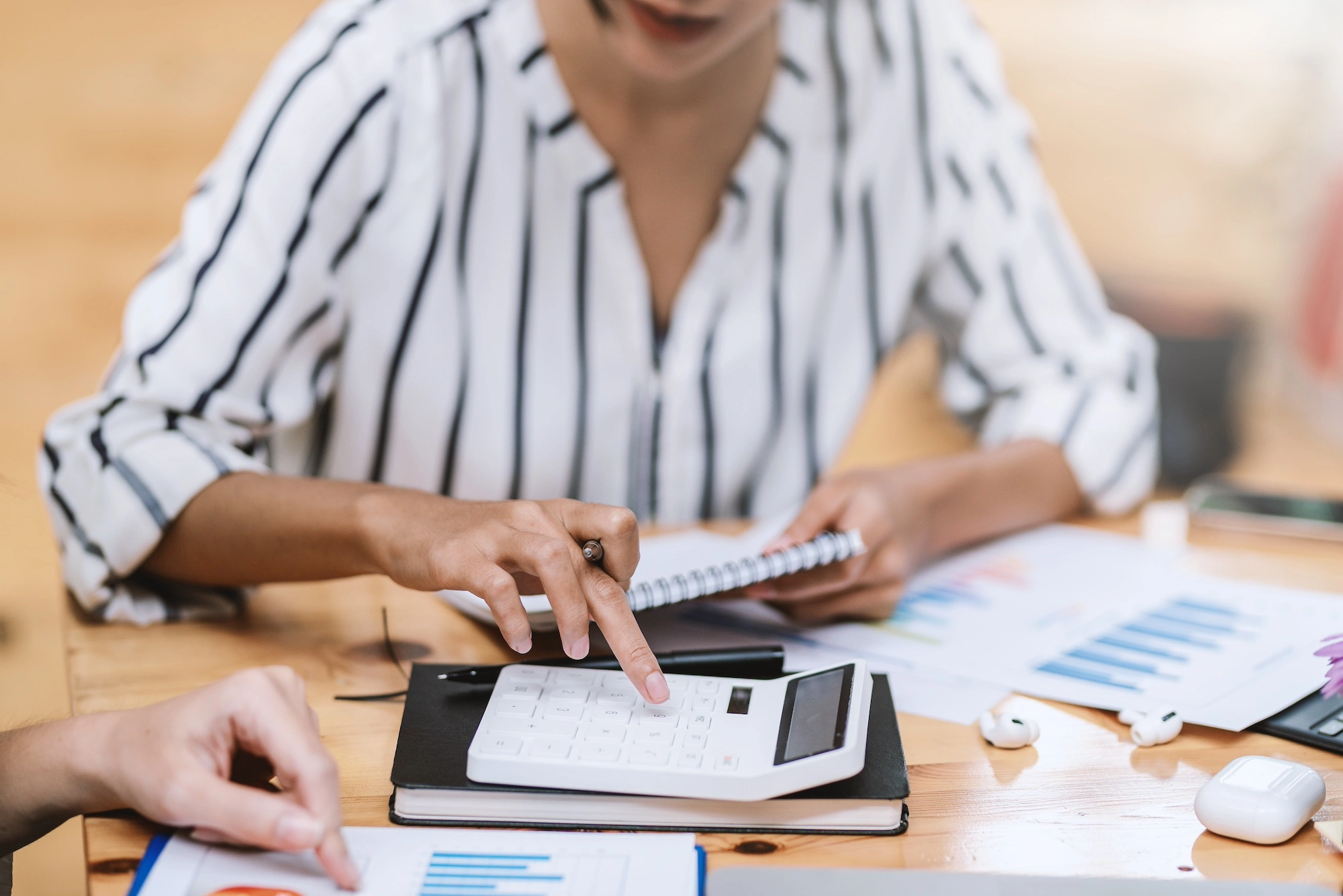 businesswoman doing bookkeeping with a calculator